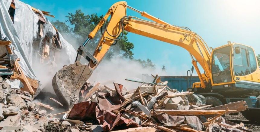 Excavator performing demolition