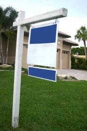 Sign on white wooden post in a residential yard