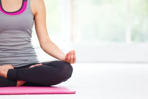 Person Sitting on Yoga Mat