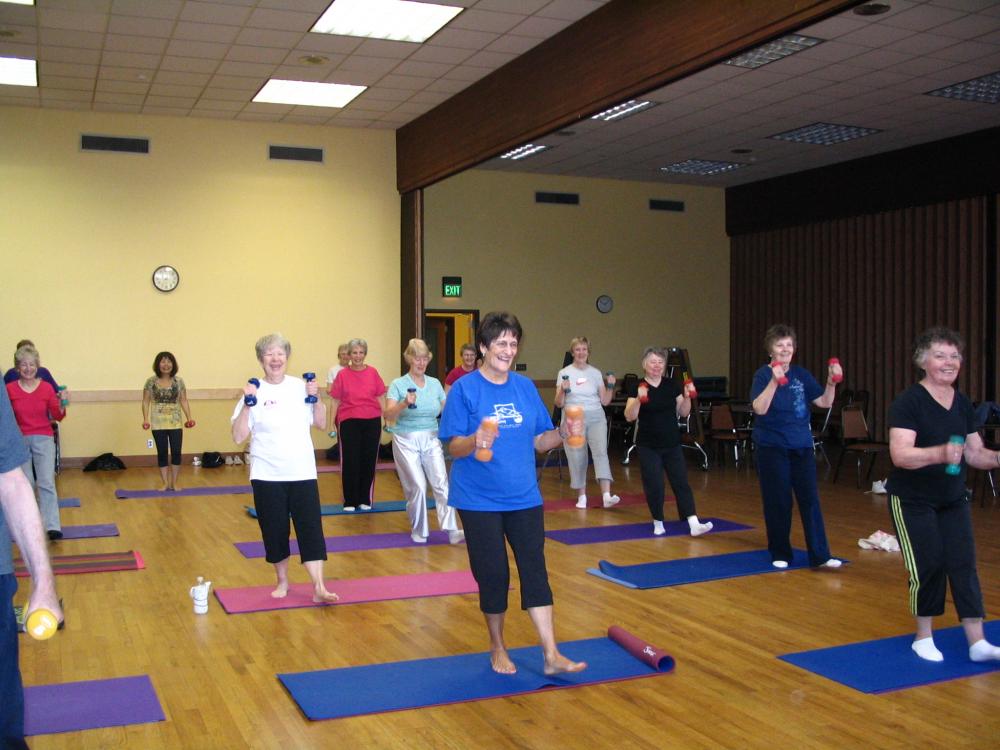 People Standing on Yoga Mats with Weights