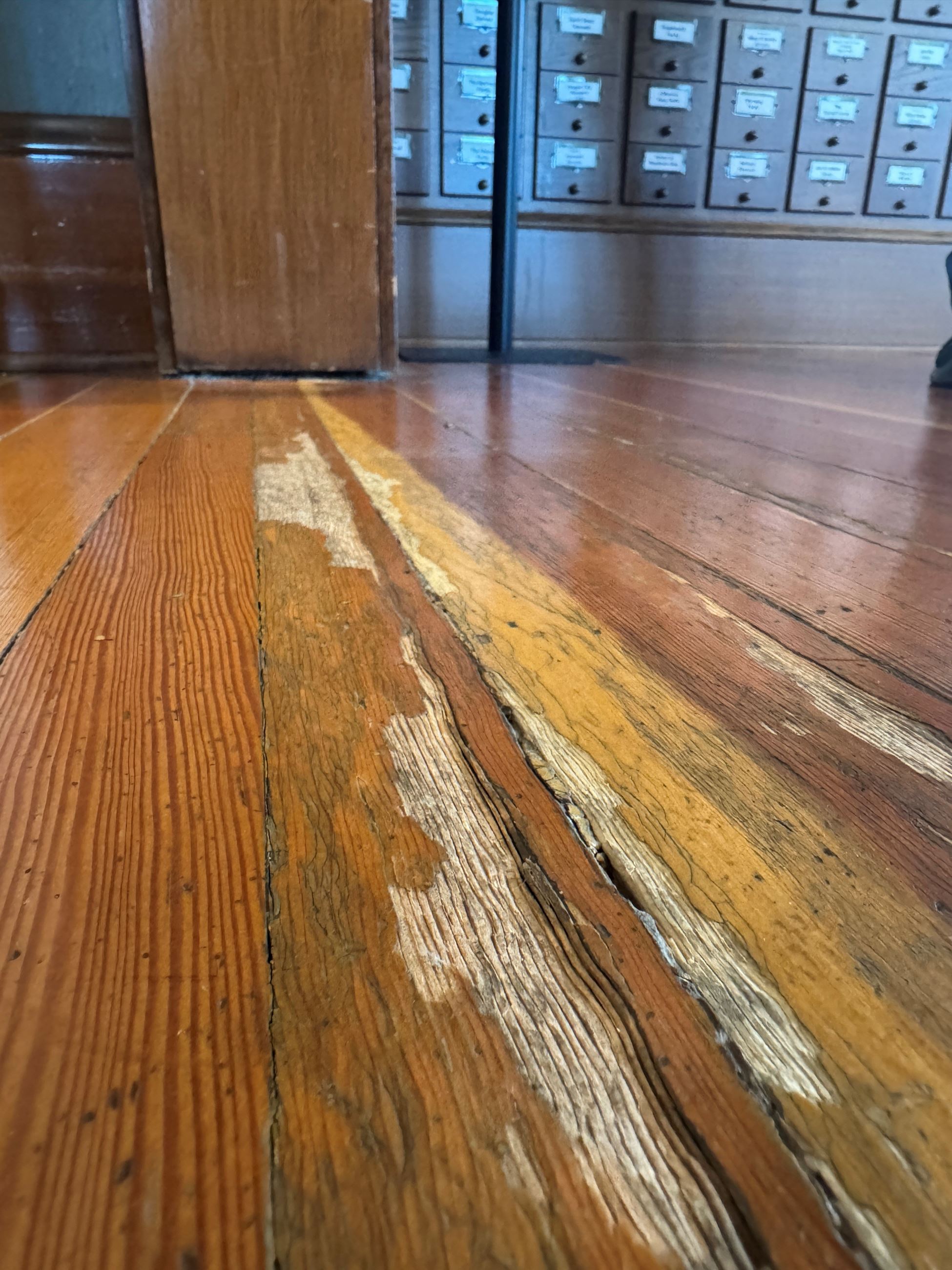 Image of badly worn floor in Carnegie library that needs replacing